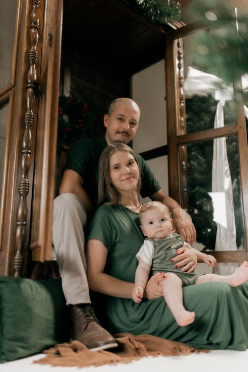 Free A loving family of three enjoys a peaceful moment indoors, captured beautifully in natural light. Stock Photo