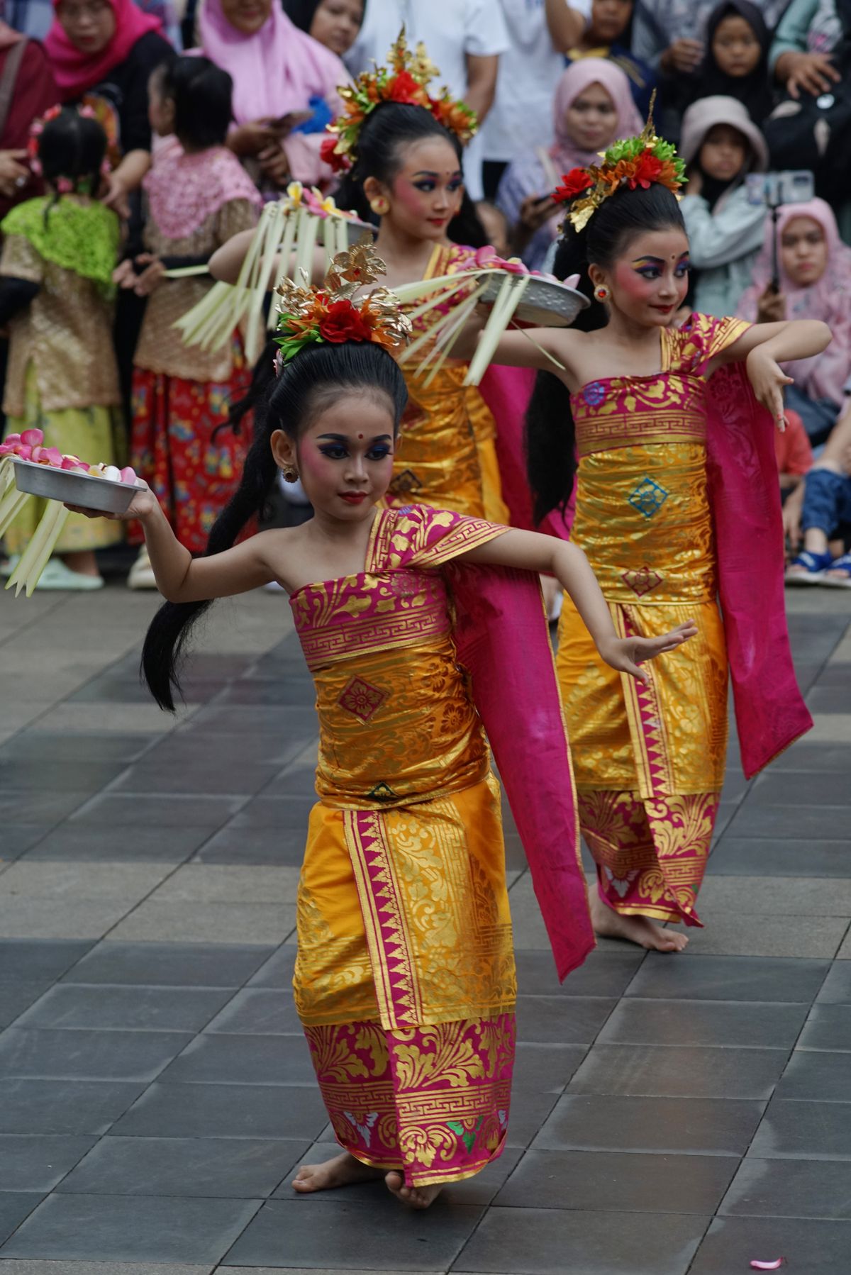 Young Balinese dancers performing in traditional clothing