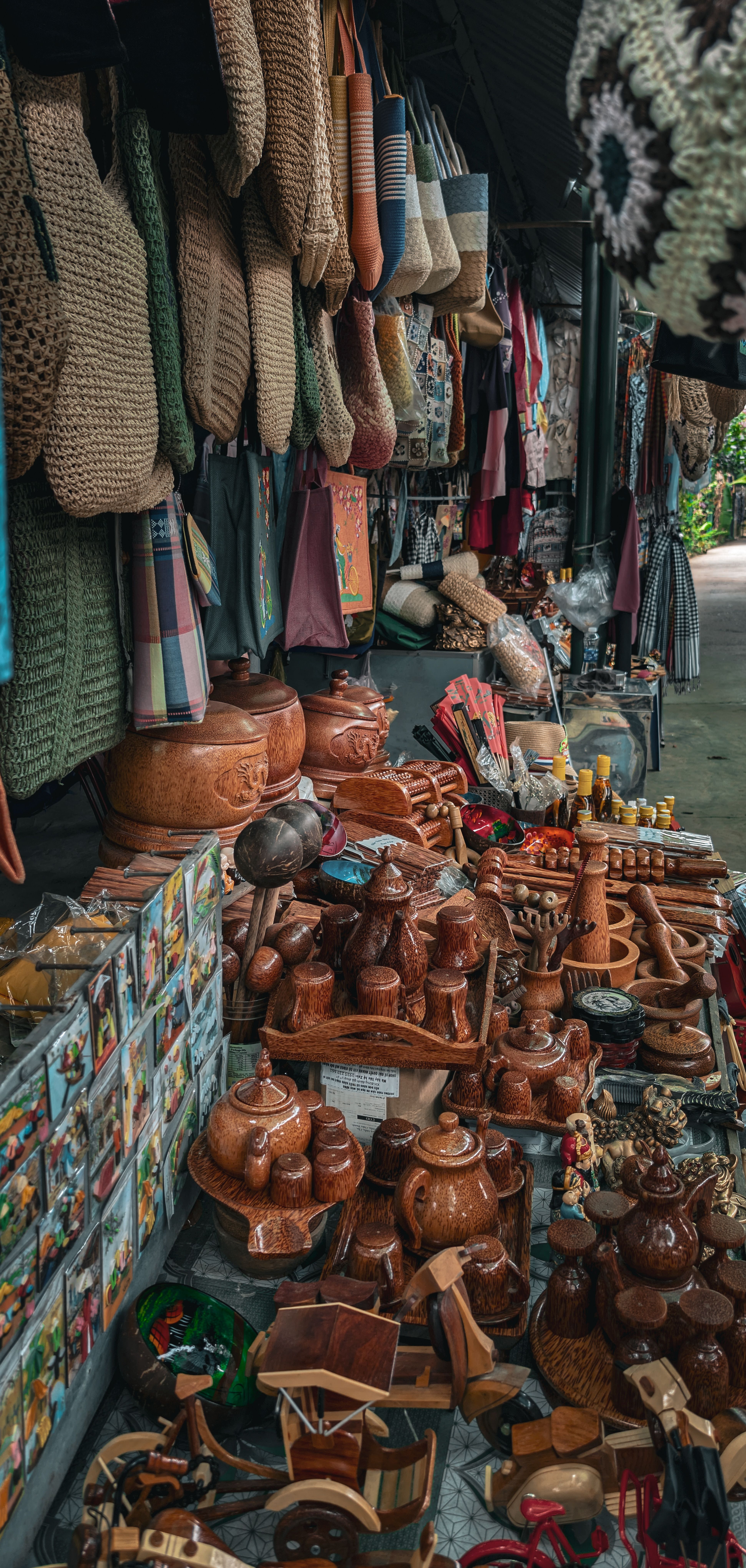 Colorful display of traditional handicrafts at a bustling Vietnam market stall. Explore local culture.