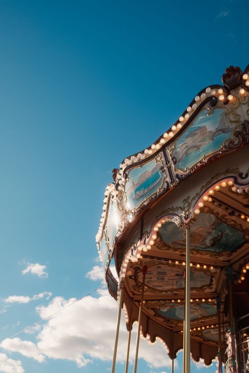 Free A classic carousel with ornate details under a bright blue sky in Cascais, Portugal. Stock Photo
