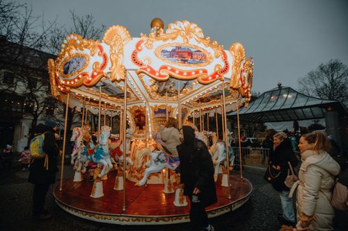 Free Vibrant carousel with children and adults at a festive winter evening carnival. Stock Photo