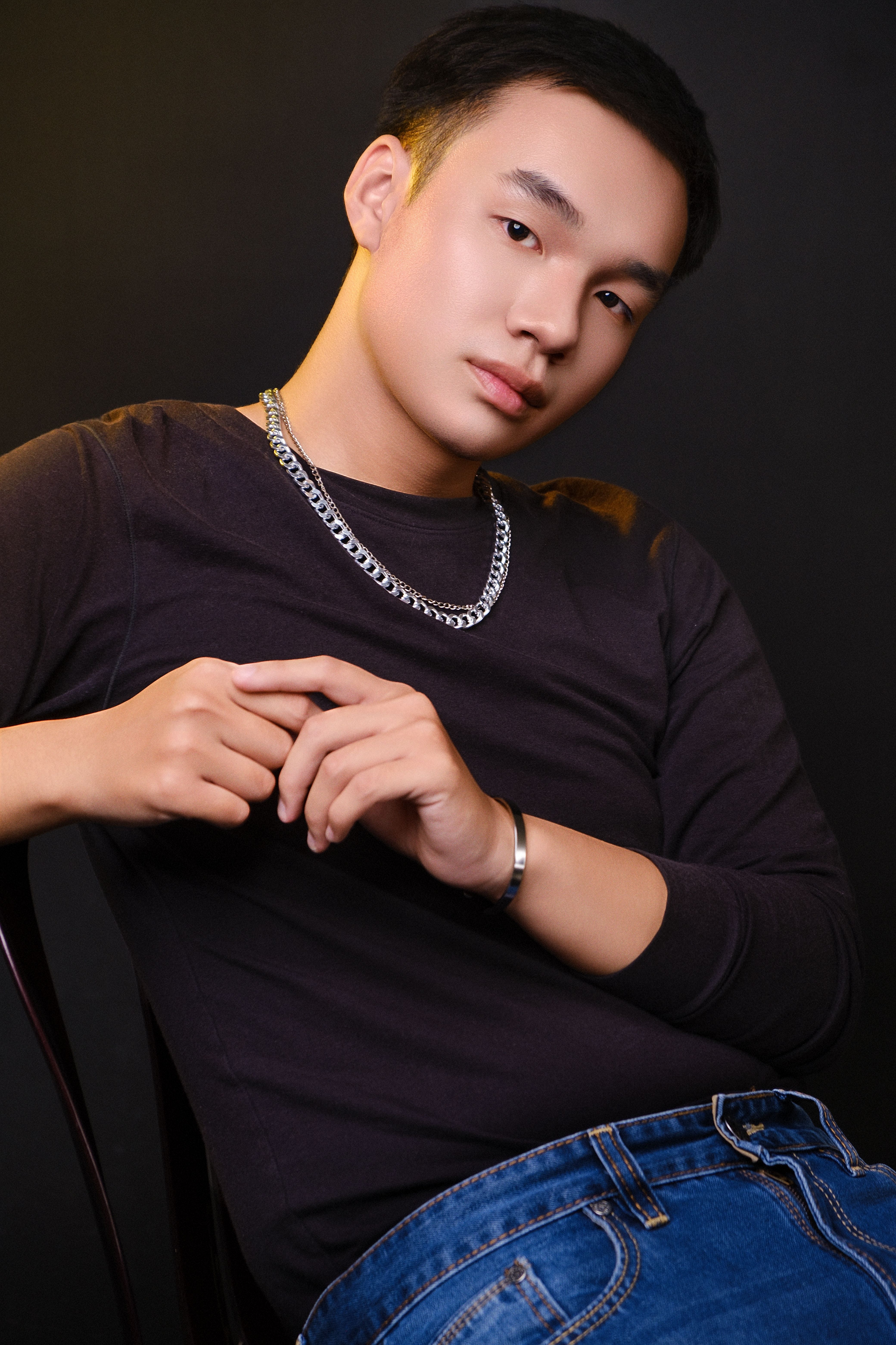 Stylish portrait of a young man with dramatic lighting and a serious expression.