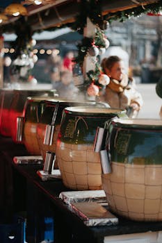 Vibrant festive market setup in Hungary with steaming pots and ornaments.