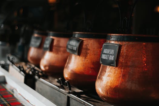 Close-up of traditional copper pots with Hungarian labels at a Budapest market.