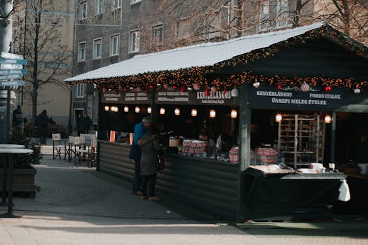 Festive Christmas market stall in Budapest offering traditional Hungarian food and drinks.
