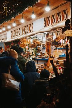 Cozy evening at a Hungarian Christmas market with handcrafted goods and warm atmosphere.