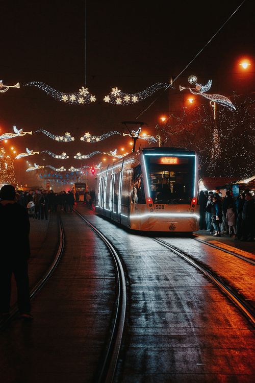 Free A beautifully decorated tram on a festive night in Budapest, Hungary, with vibrant holiday lights. Stock Photo