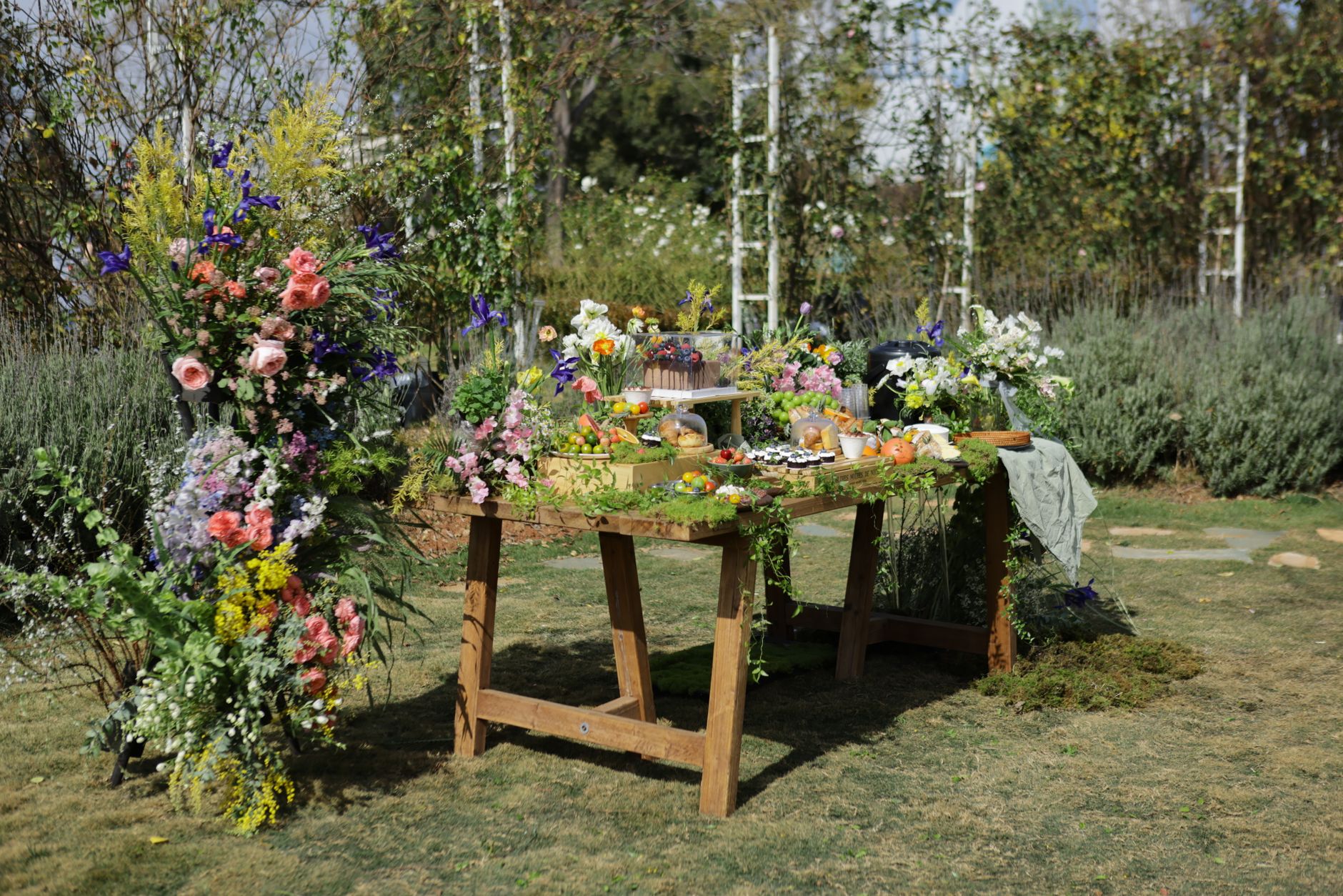 Beautiful outdoor garden setup with floral decor and delicious food spread.