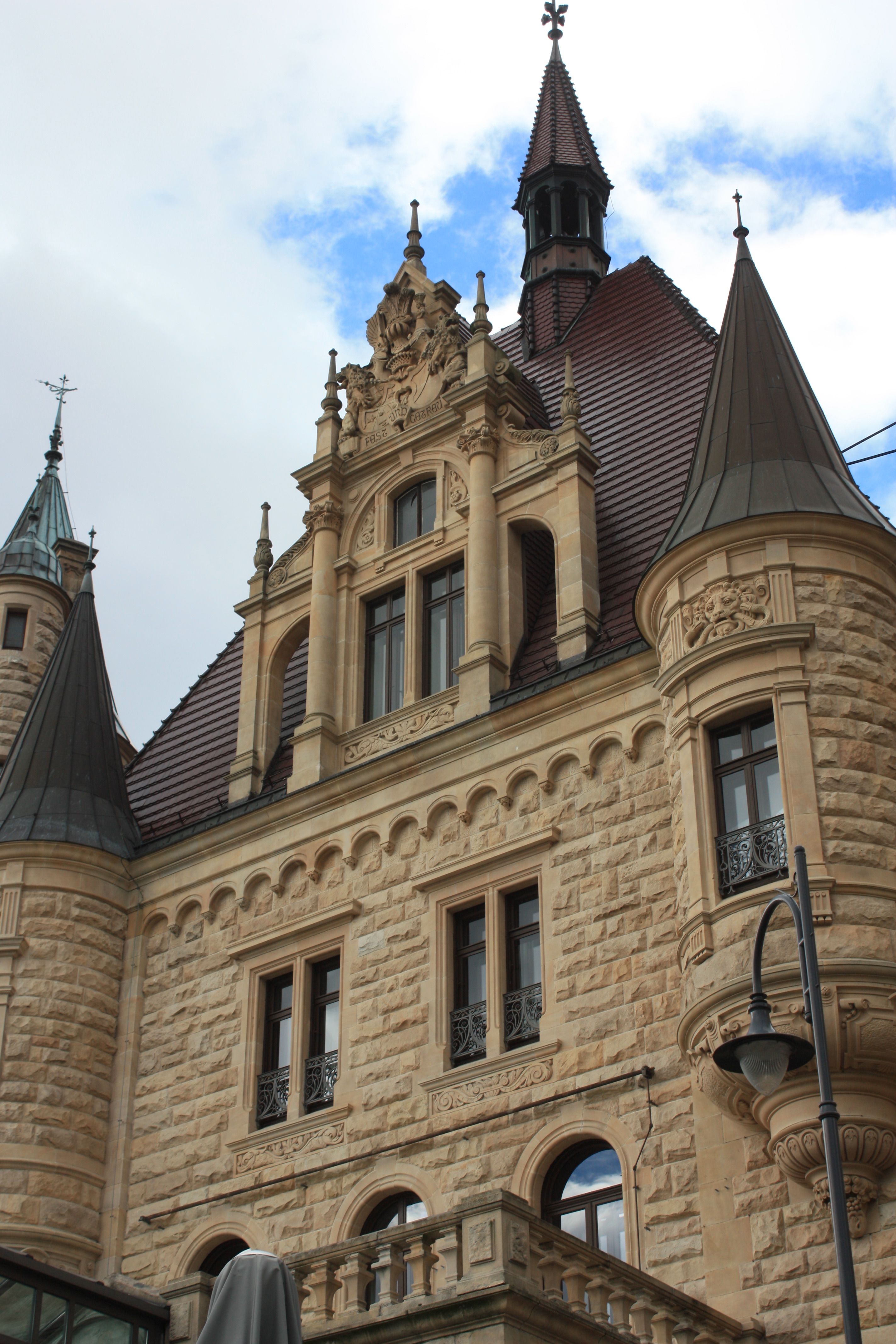 Gothic Revival Style Castle Facade Under Blue Sky · Free Stock Photo