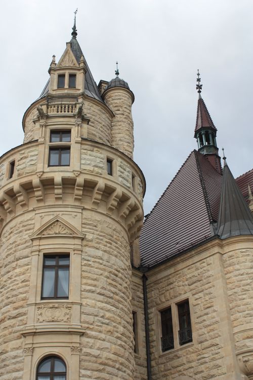 Free Close-up of a medieval European castle tower with ornate turrets and stonework. Stock Photo