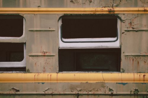 Free Old abandoned train with rust and peeling paint, showcasing decay and urban exploration. Stock Photo