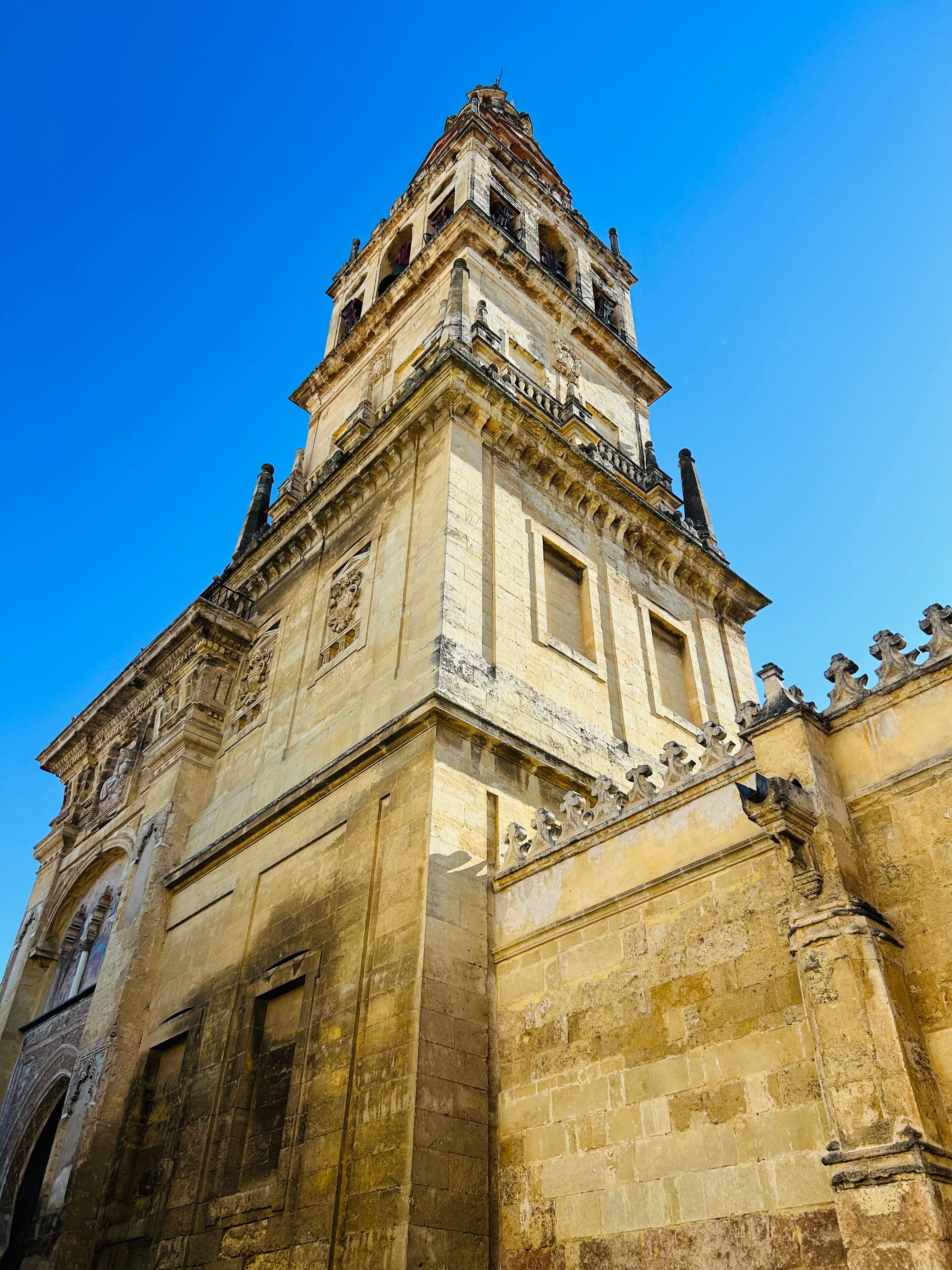 Majestic Bell Tower Against Clear Blue Sky · Free Stock Photo