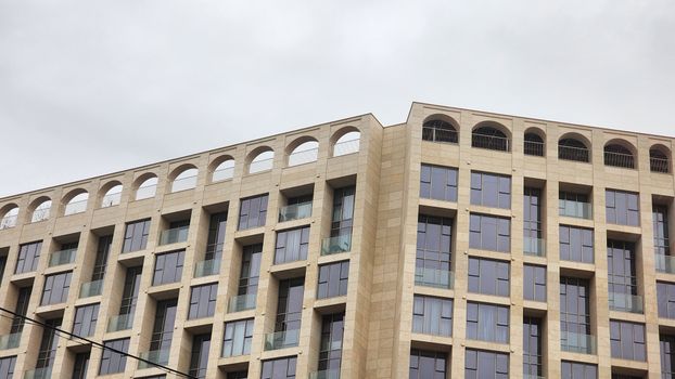 A modern architectural building with elegant geometric design and large windows.