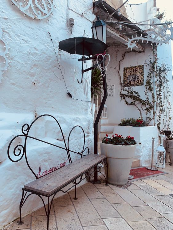 Charming Mediterranean Courtyard with Ornate Bench · Free Stock Photo