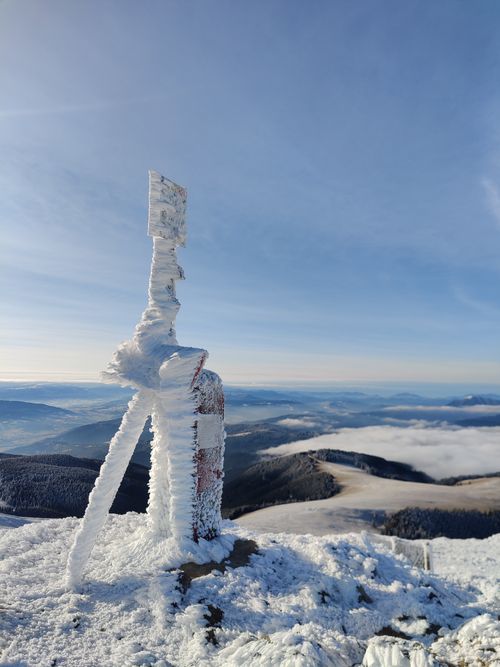 Free Frozen signpost on snow-capped mountain with winter landscape view. Stock Photo