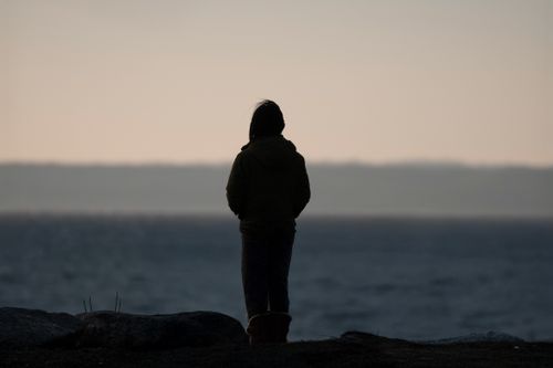 Free Silhouette of a person meditating by the sea in Stamford, Connecticut during a peaceful dawn. Stock Photo