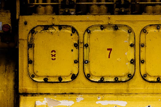 Detailed shot of a yellow industrial machinery panel showing texture and numbers.