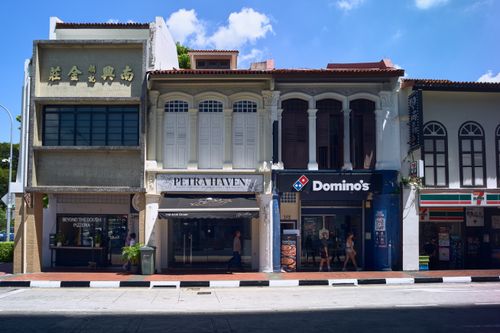 Free Colorful shophouses on Arab Street with modern storefronts and traditional architecture, captured in bright daylight. Stock Photo
