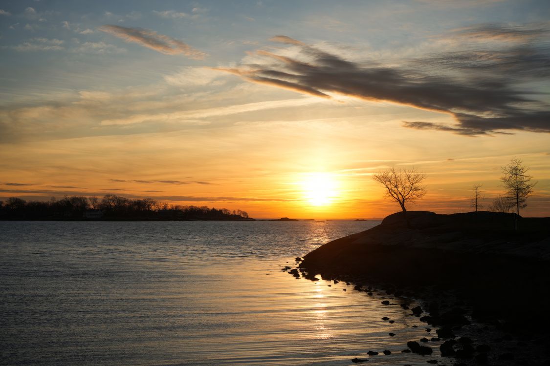 Serene Sunset over Tranquil Water Landscape · Free Stock Photo