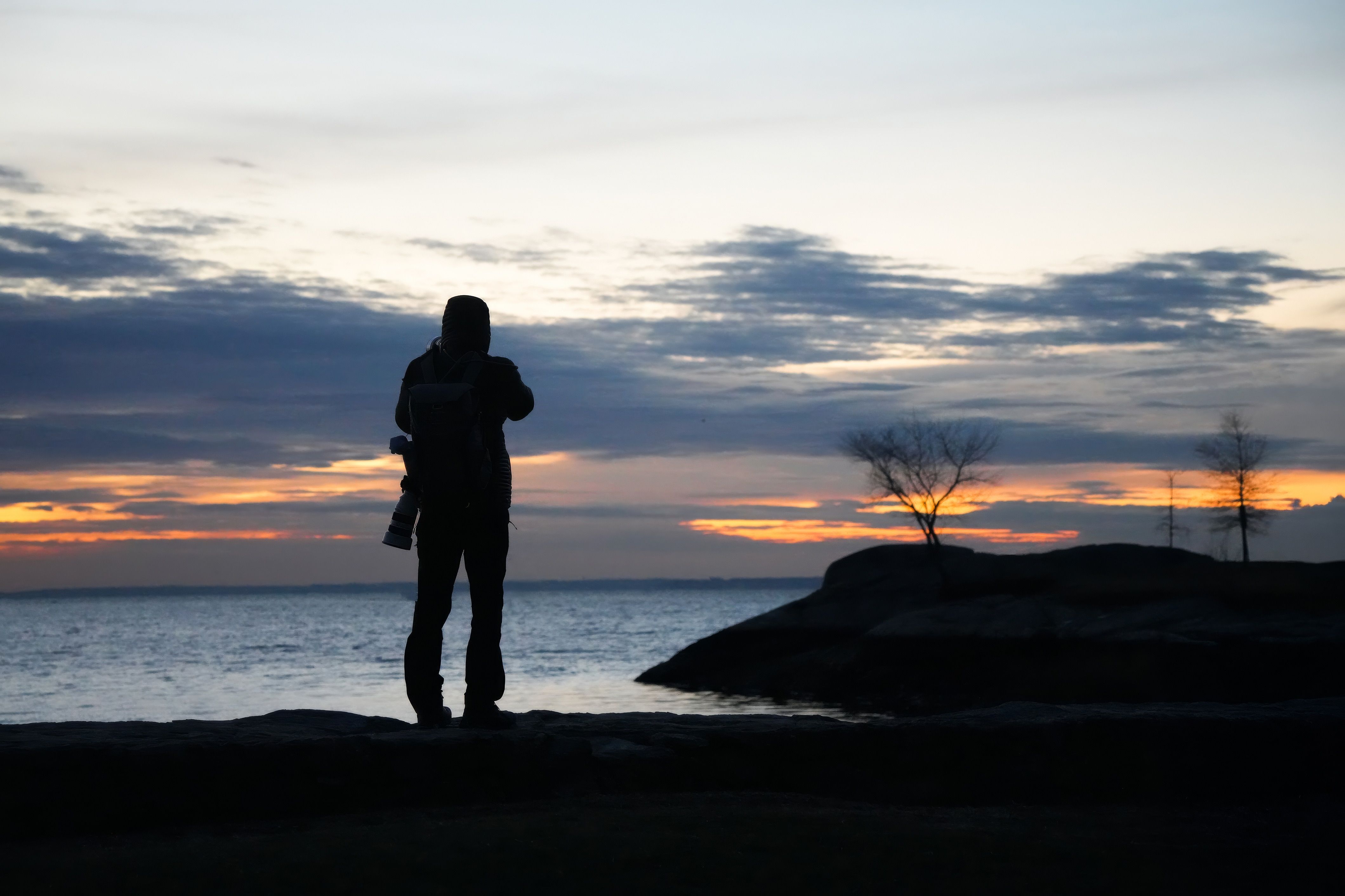 Silhouette of Photographer at Sunset by the Ocean · Free Stock Photo
