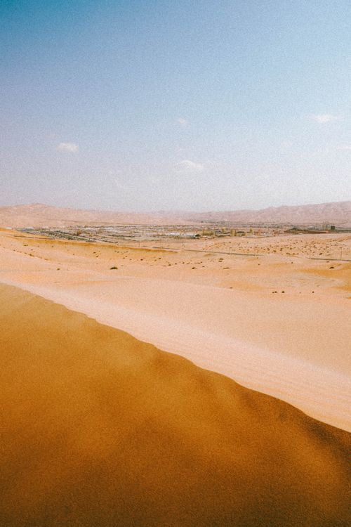 Free Scenic landscape of golden sand dunes under clear blue sky in Abu Dhabi, United Arab Emirates. Stock Photo