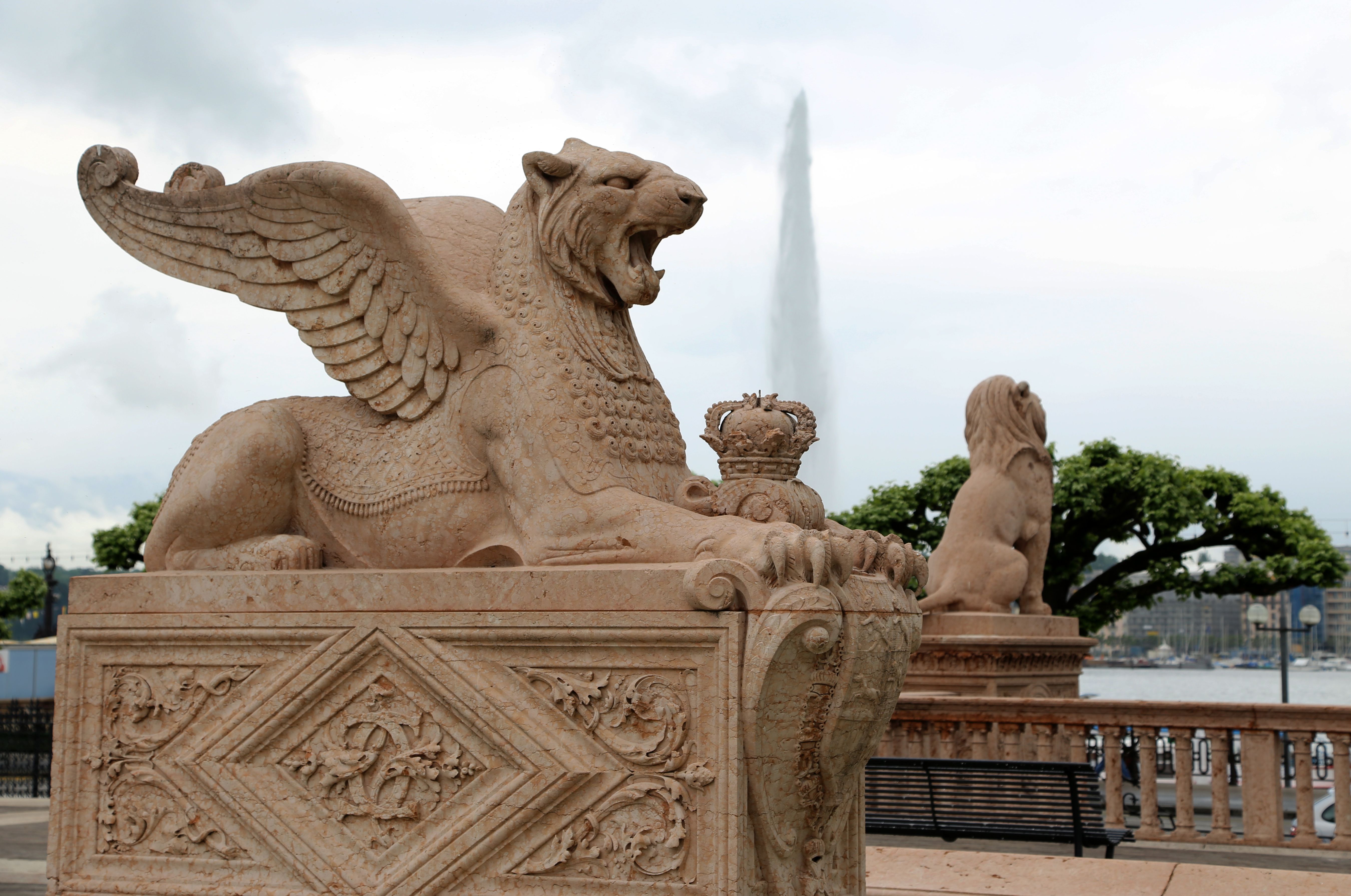 Stone sphinx statue by Lake Geneva with Jet d