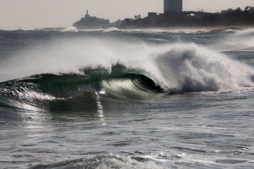 Free Dynamic scene capturing ocean waves crashing under a lighthouse skyline in Sokcho. Stock Photo