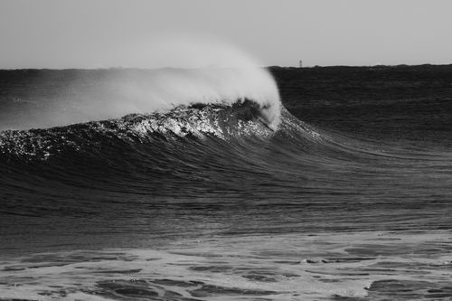 Free A dramatic black and white photo capturing a powerful ocean wave crashing, with a moody and dramatic feel. Stock Photo