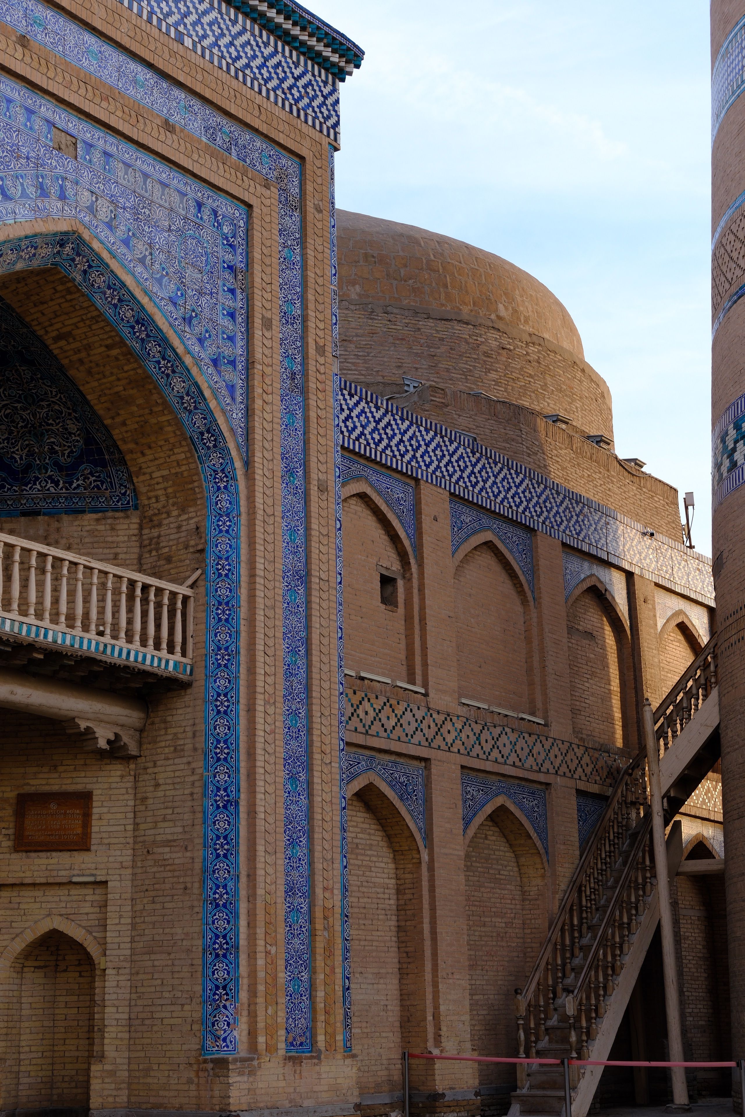 A stunning example of Islamic architecture featuring intricate mosaic tile work and arches.
