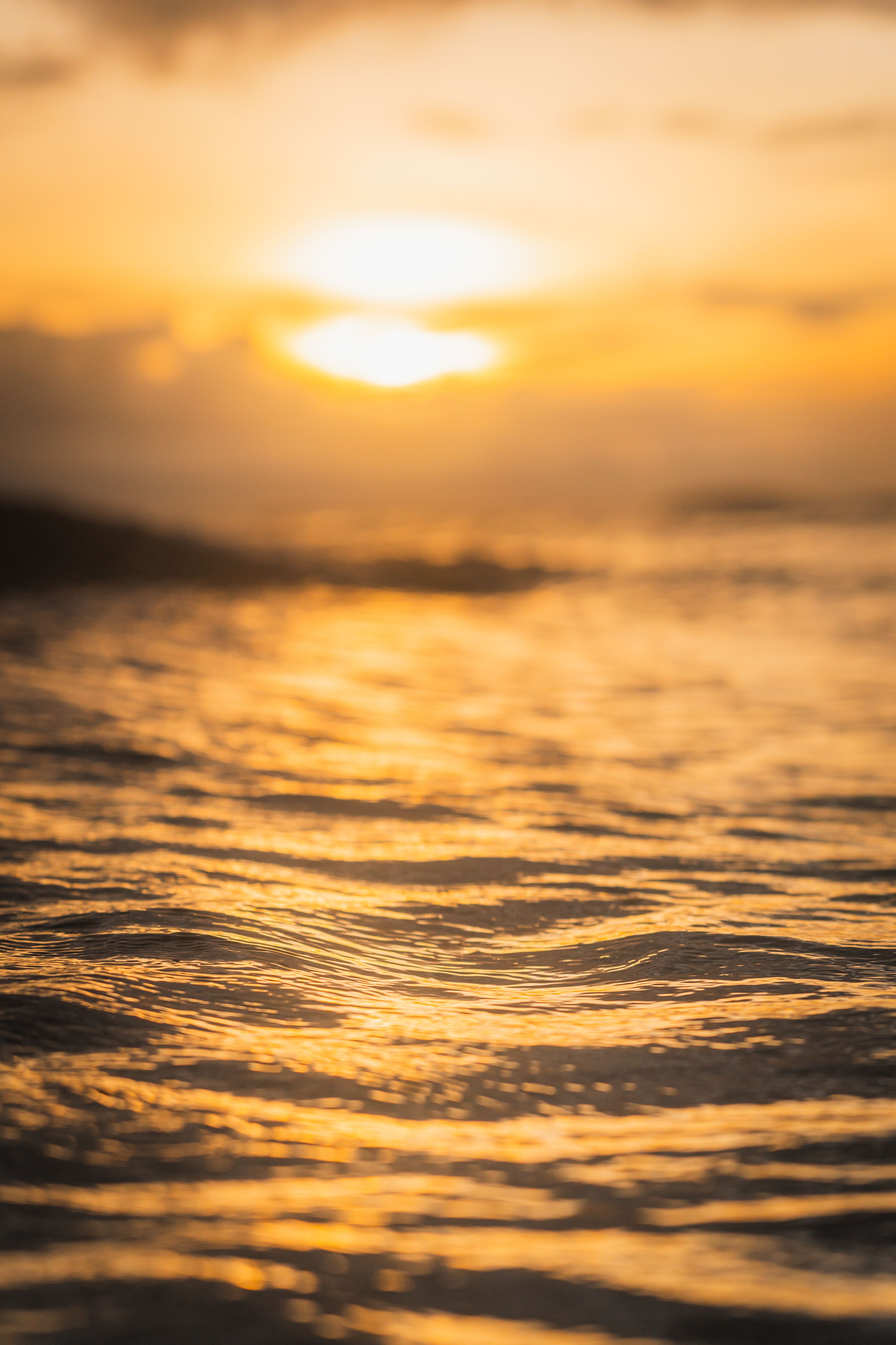 golden sunset over a tranquil ocean with soft orange waves