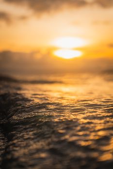 Breathtaking view of a golden sunset reflecting on peaceful ocean waves.