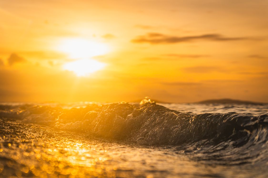 Golden Sunset Over Ocean Waves · Free Stock Photo