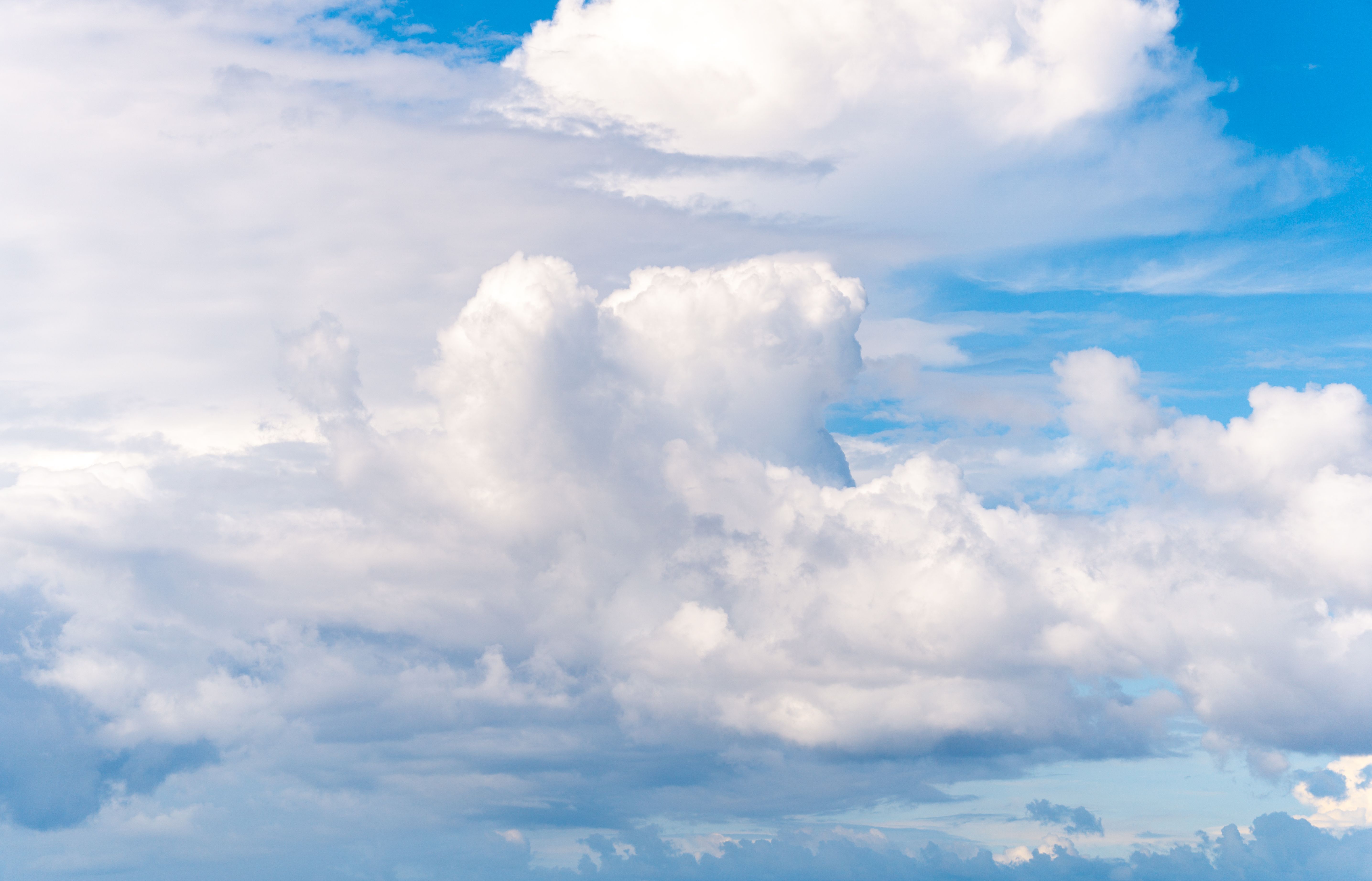 Fluffy White Clouds in a Bright Blue Sky · Free Stock Photo