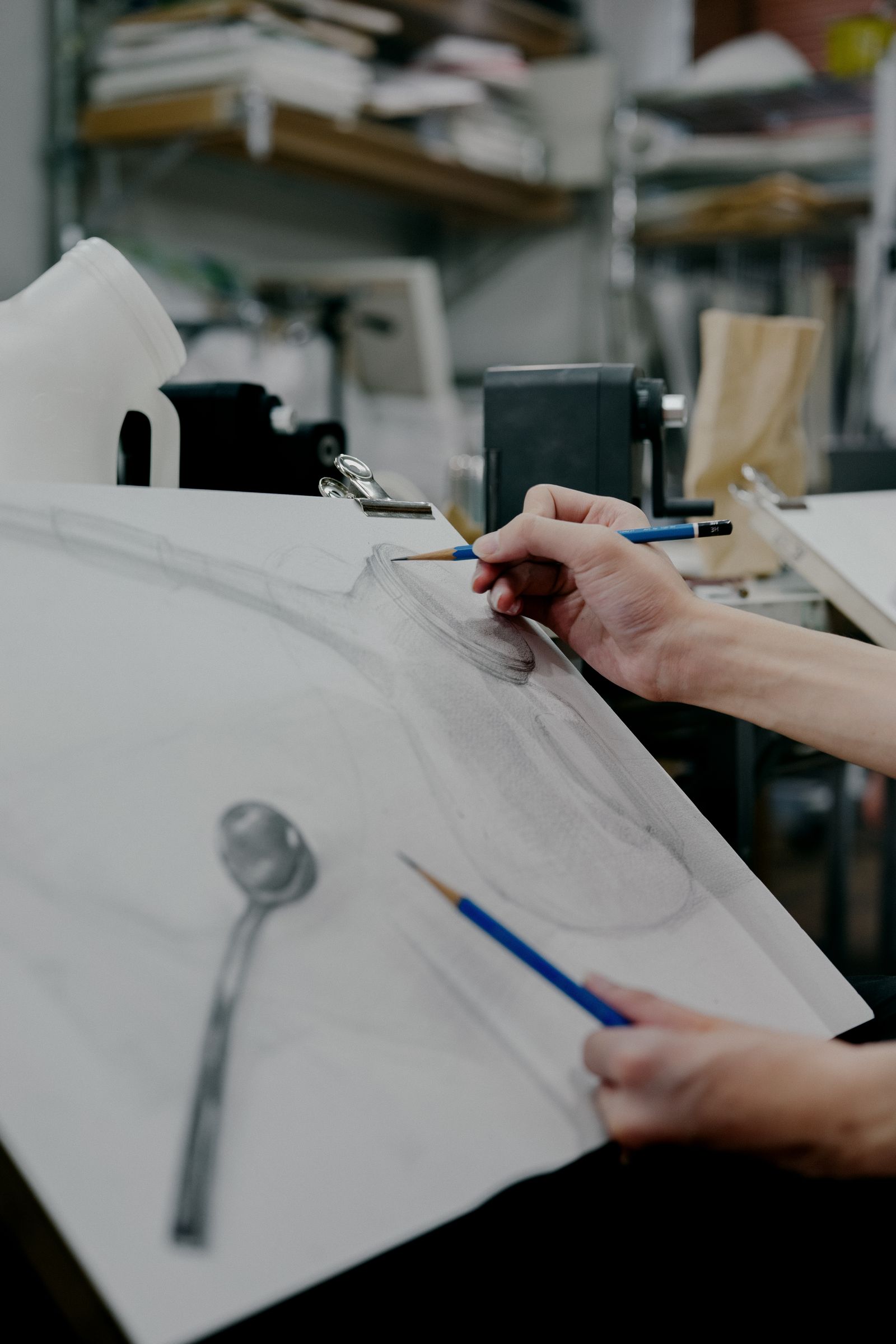 Art student sketching a still-life arrangement in a studio