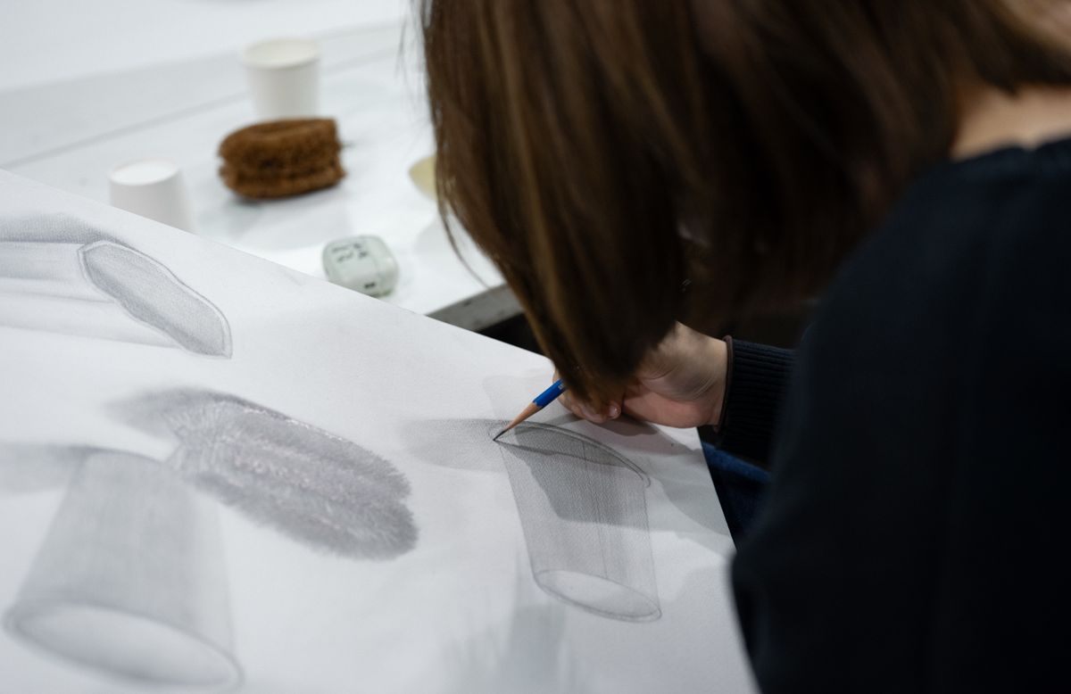 Art student completing an observational still-life drawing