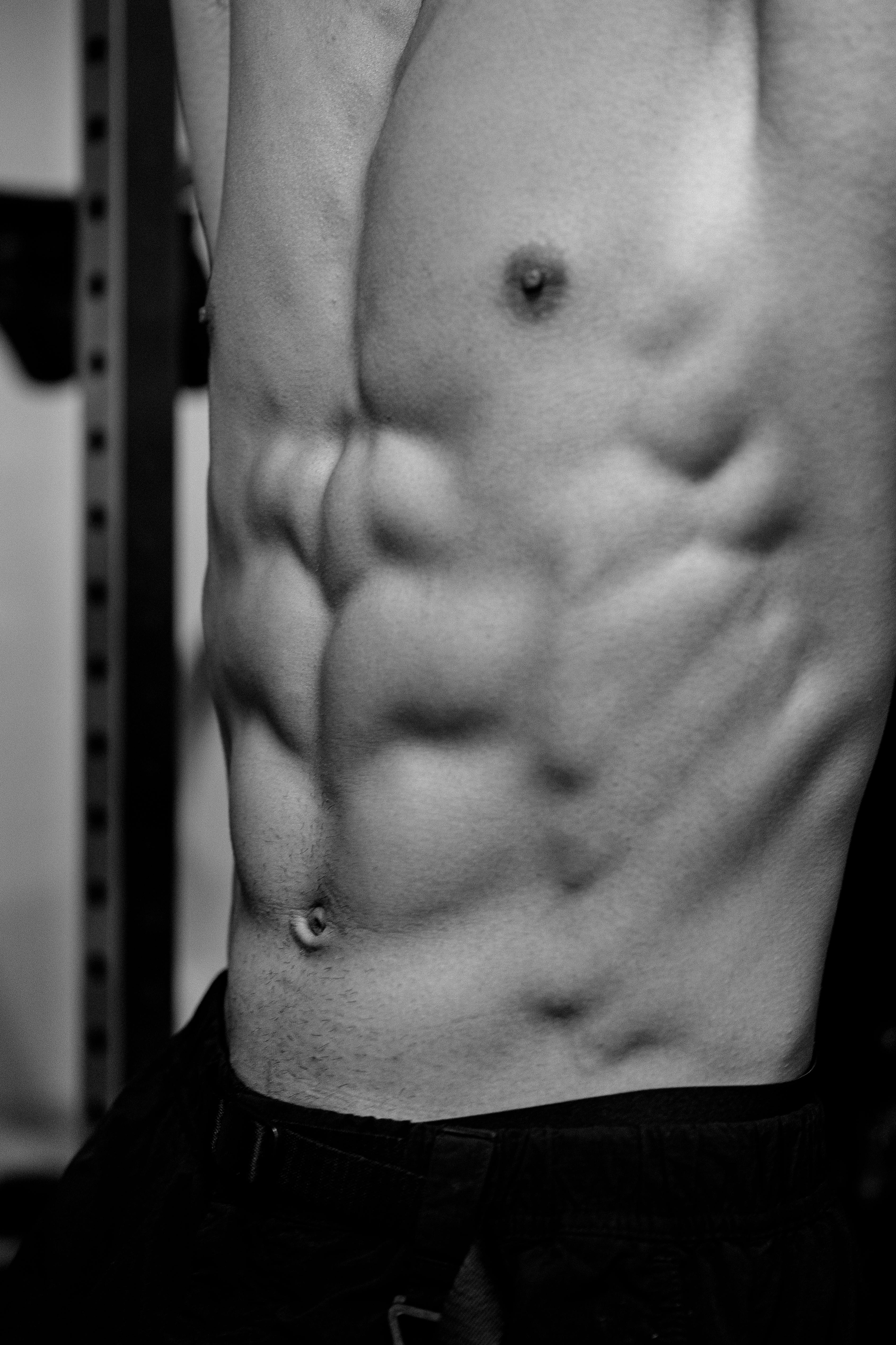 A striking black and white photo depicting well-defined male abs, showcasing fitness and strength.
