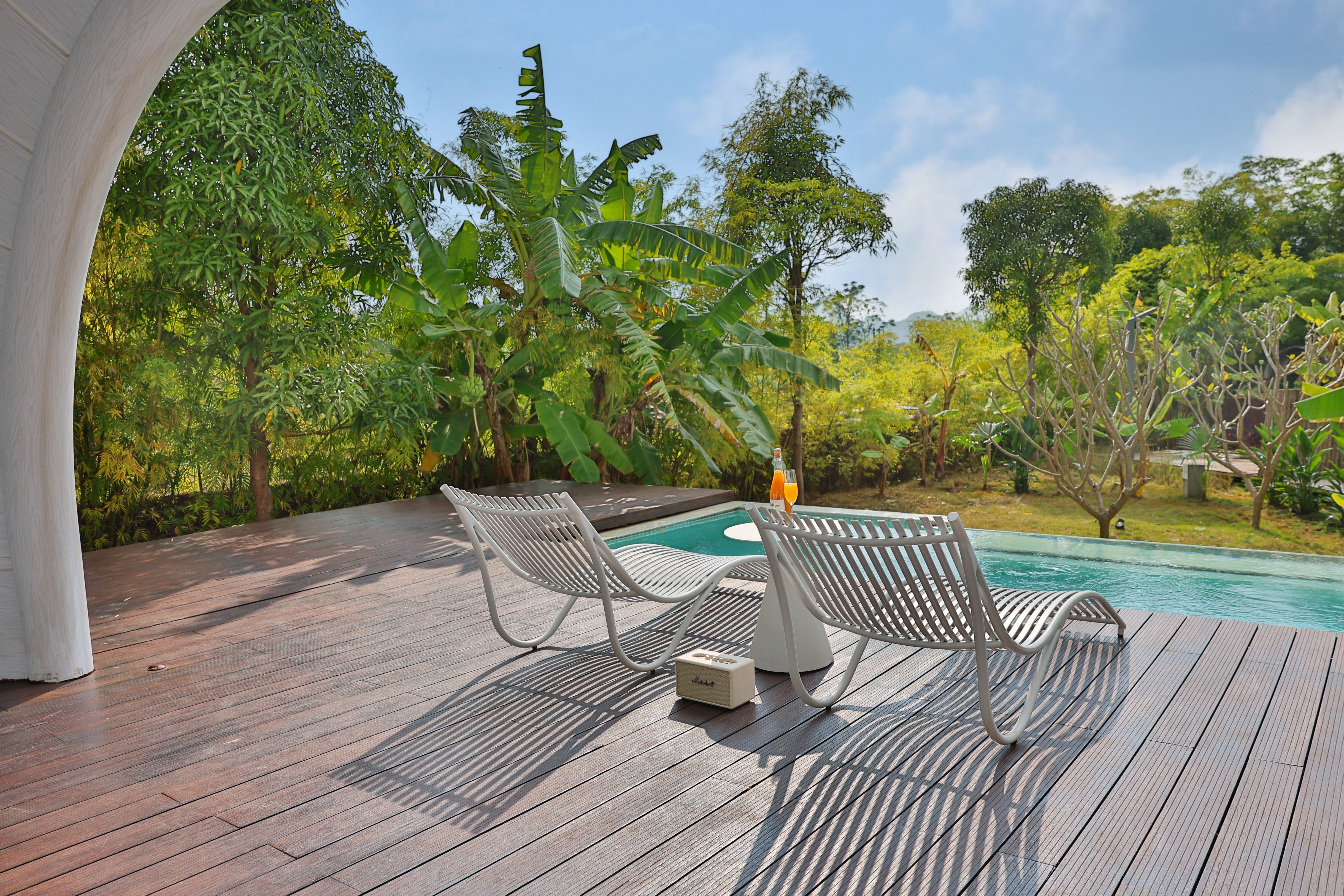Relaxing Poolside Retreat with Modern Chairs · Free Stock Photo
