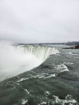 Stunning capture of Niagara Falls with powerful water flow over the edge.
