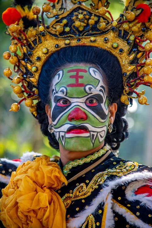 Free Vibrant portrait of a person in traditional Asian theatrical costume with ornate face paint and headpiece. Stock Photo