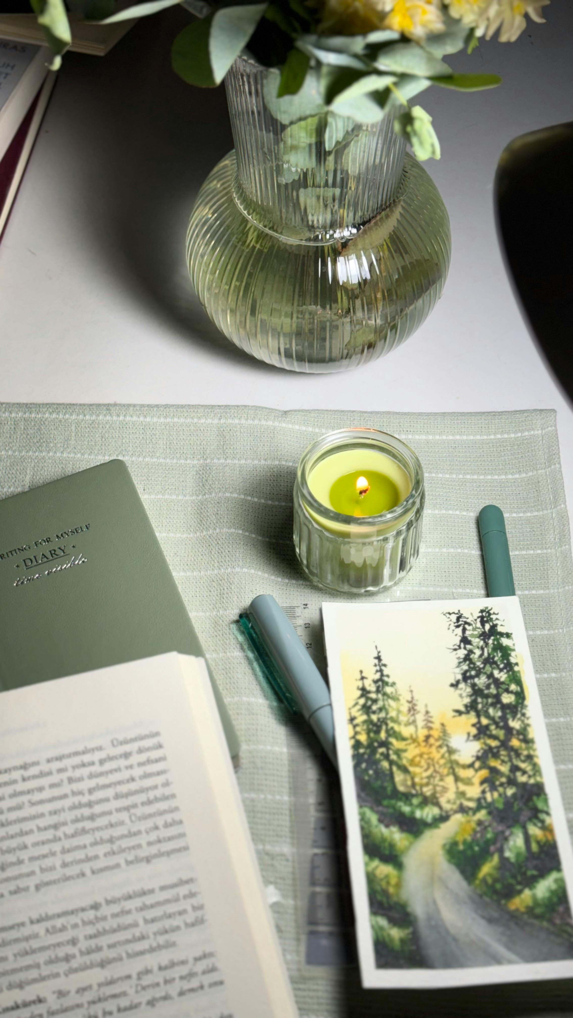 Notebook open with aesthetic journaling setup and soft lighting