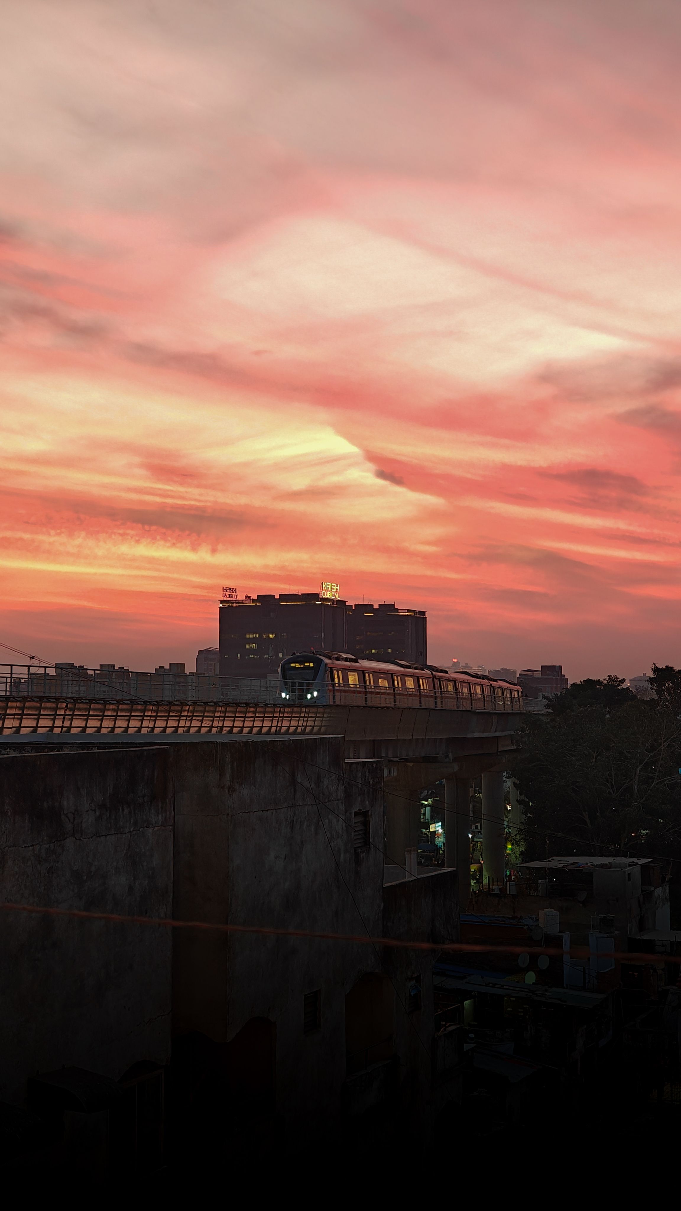 Train under vibrant sunset sky · Free Stock Photo