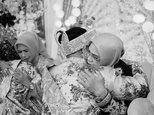 Free Heartfelt moment captured at a traditional Indonesian wedding ceremony, showing warmth and tradition. Stock Photo