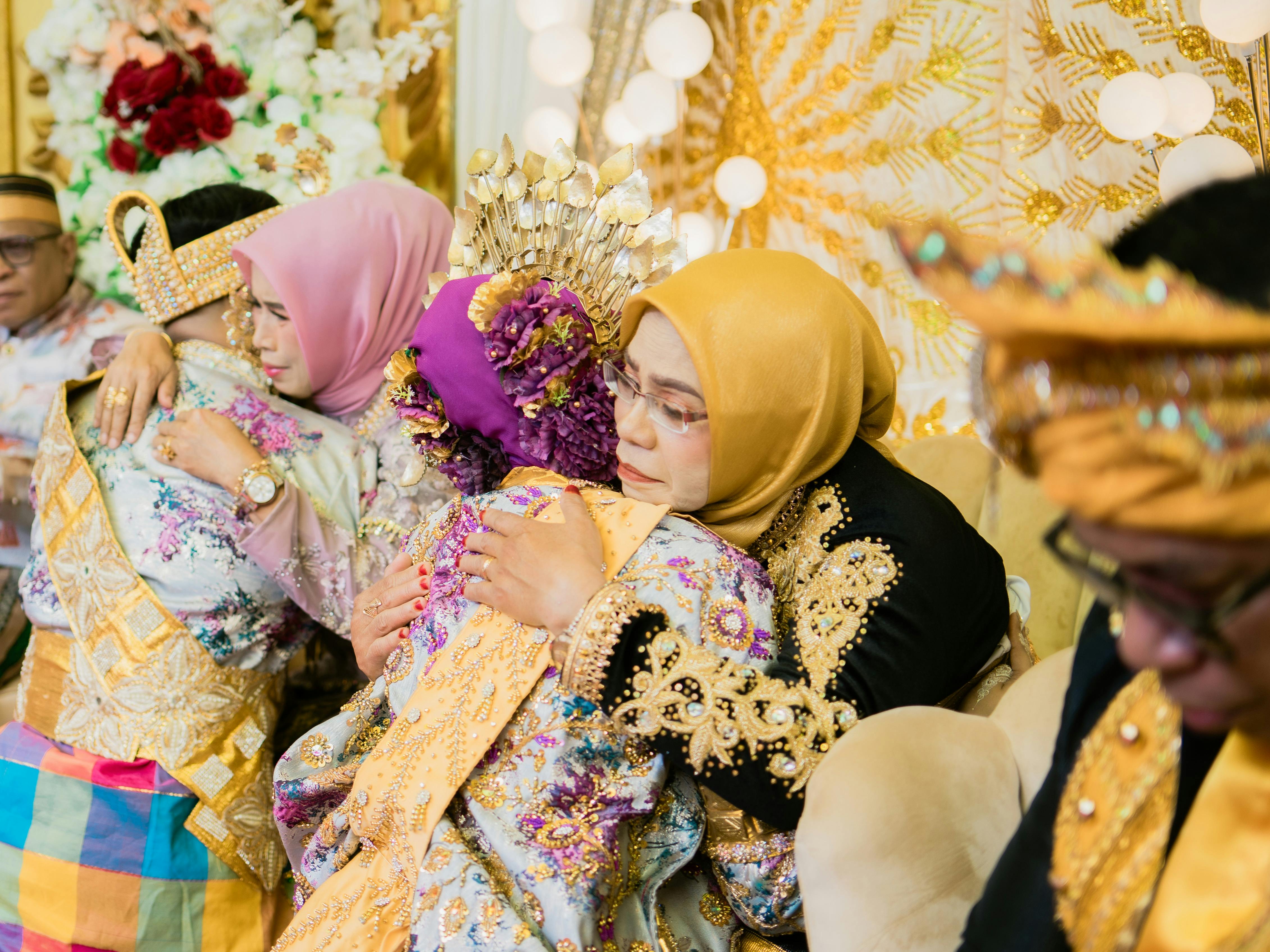 Emotional embrace during a vibrant traditional Indonesian wedding ceremony in Kendari.