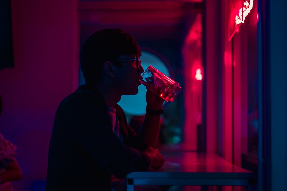 Man Drinking Beside Wall