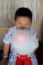 Child Enjoying Large Cotton Candy Indoors