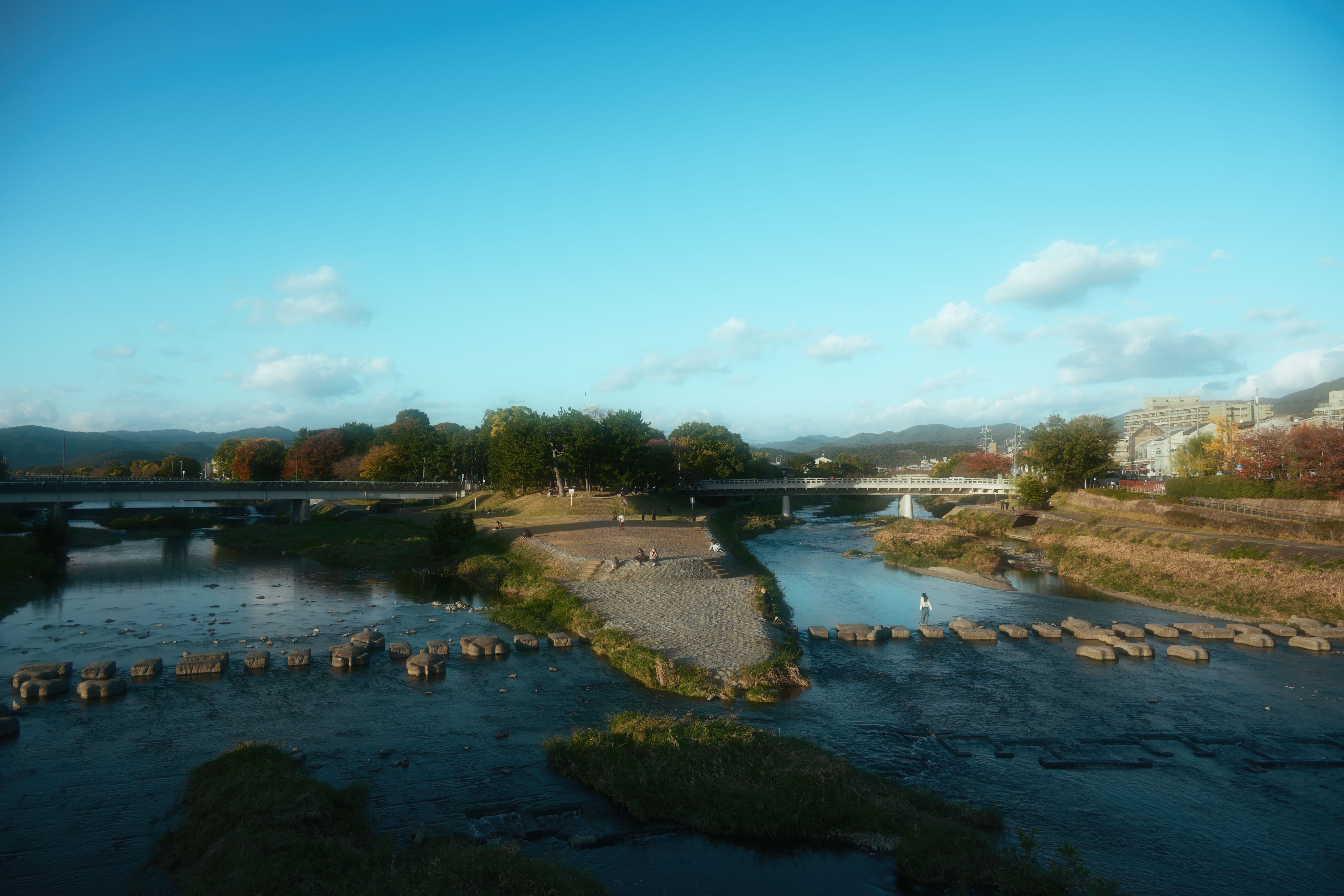 Scenic River View with Stone Path and Bridges · Free Stock Photo