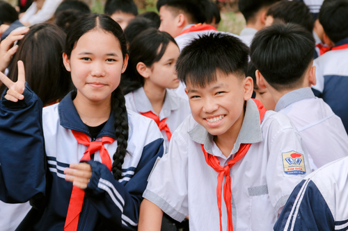 Free Happy students in school uniforms smiling outdoors during daytime. Stock Photo