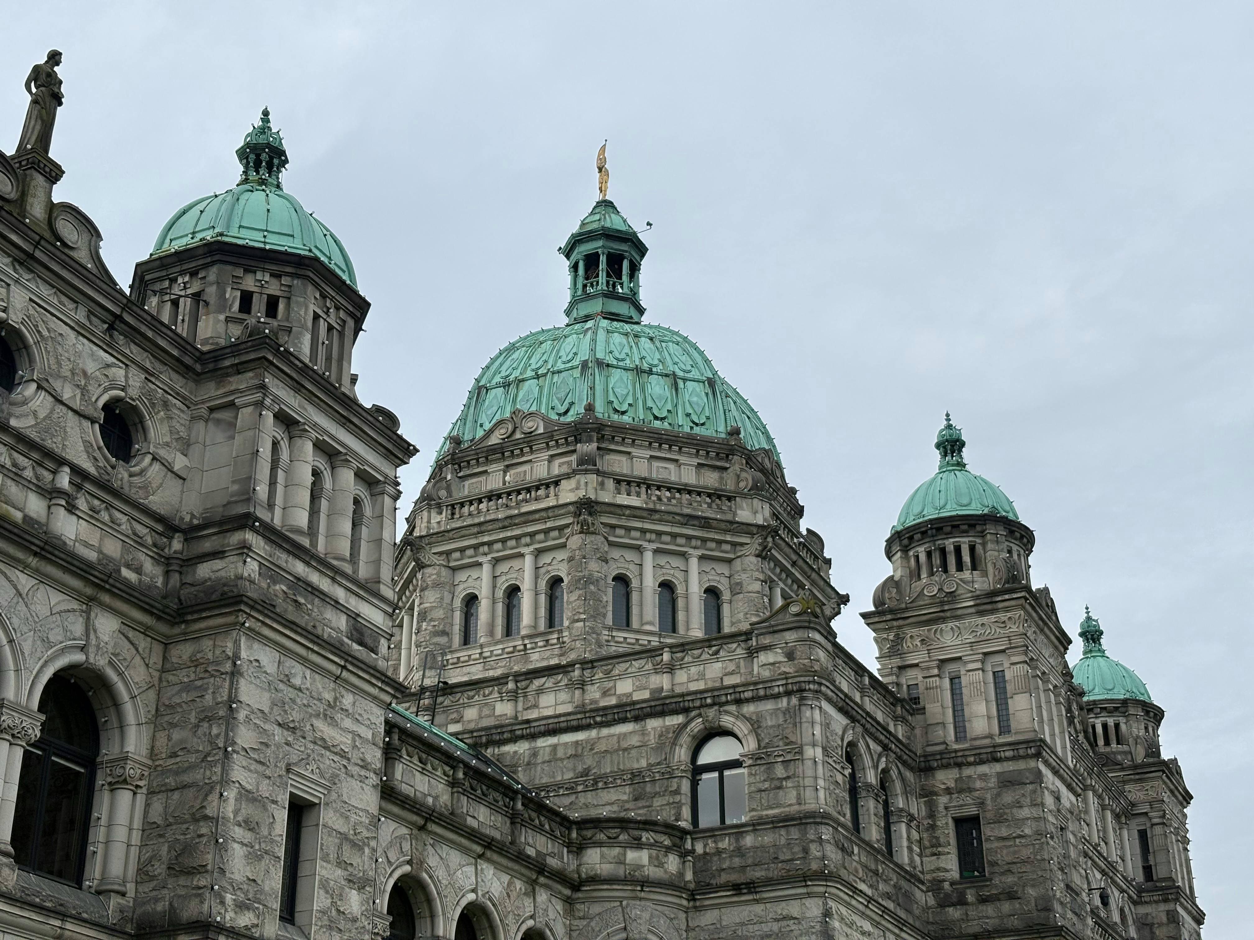 A close-up view of the historic Parliament Building in Victoria, British Columbia with its iconic green domes. - Victoria