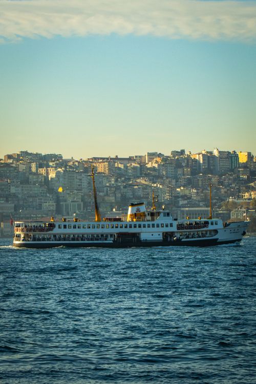 Free Ferry sailing across Bosphorus with Istanbul cityscape in the background. Stock Photo