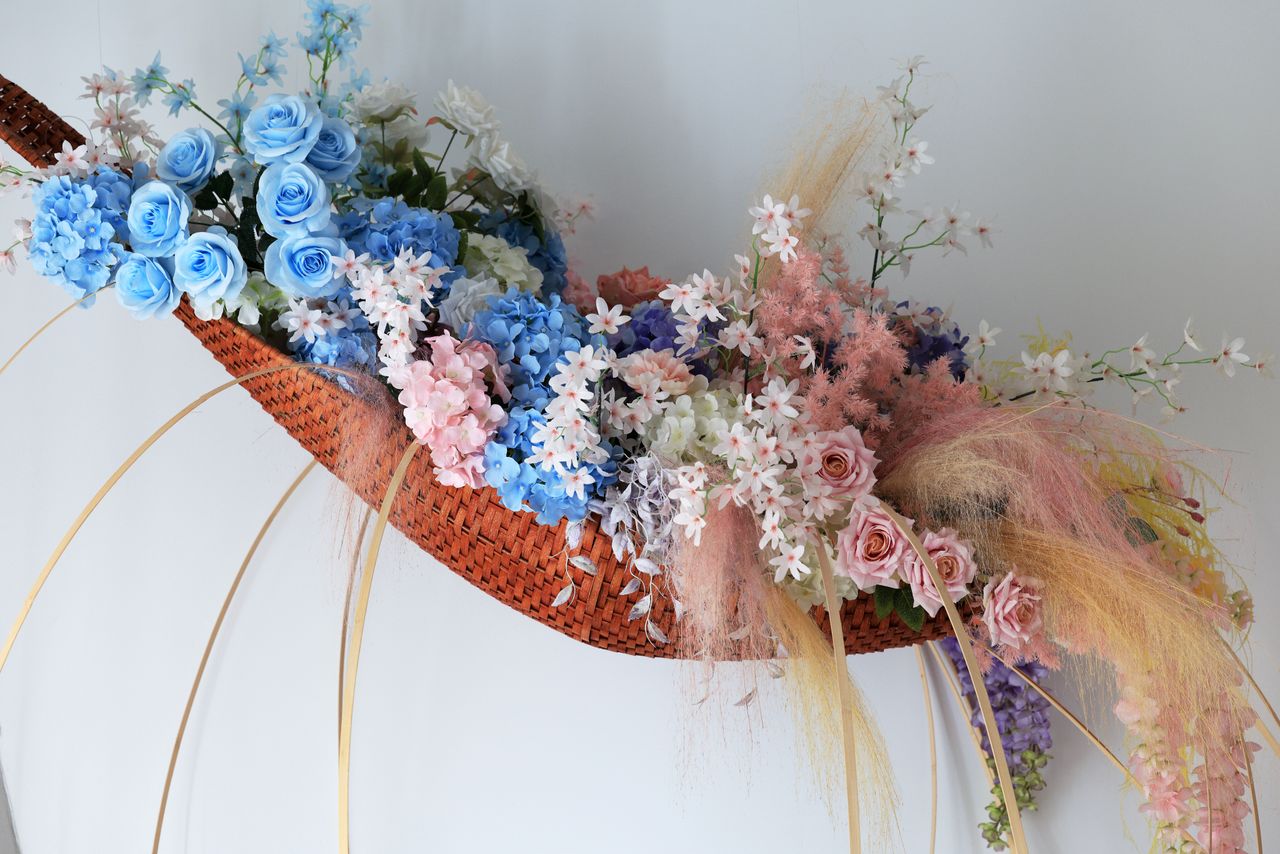 beautiful basket of blue roses hydrangeas and pastel flowers ideal for